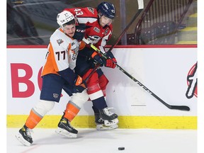 WINDSOR, ONTARIO. JANUARY 16, 2022 - Zacharie Giroux, left, of the Flint Firebirds tangles with Louka Henault of the Windsor Spitfires on Sunday, January 16, 2022 at the WFCU Centre in Windsor.