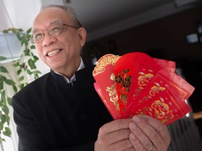 Stephen Tsui, president of the Essex County Chinese Canadian Association, holds Lucky Money envelopes for Lunar New Year celebrations at his home in Windsor on Jan. 31, 2022.
