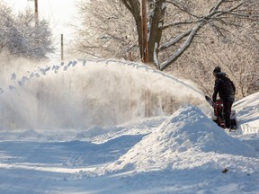 A Des Moines resident removes snow after Winter Storm Izzy in Des Moines, Iowa, U.S., January 15, 2022.