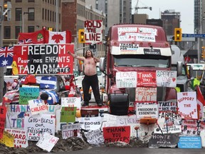 A shirtless protester participates in a blockade of downtown streets near the Parliament building as a demonstration led by truck drivers opposing vaccine mandates continues on February 16, 2022 in Ottawa.