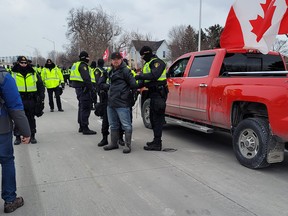Police begin arresting protesters on Huron Church Road near the Ambassador Bridge.