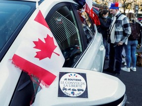 A Canadian flag is seen near a sticker reading "I support the freedom convoy" before the start of their "Convoi de la liberte" (The Freedom Convoy), a vehicular protest converging on Paris to protest COVID-19 vaccines and restrictions, in Nice, France, Wednesday, Feb. 9, 2022.