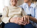A senior receives a visitor at her long-term care home.