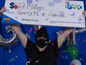 Garry Myles, of Oakville, with the $22 million from his Lotto Max win.