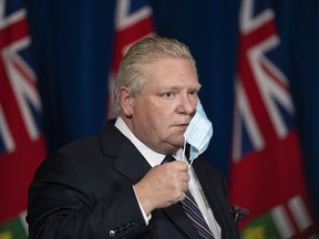 Ontario Premier Doug Ford arrives to his press conference at Queen's Park regarding the easing of restrictions during the COVID-19 pandemic in Toronto on Thursday, January 20, 2022.