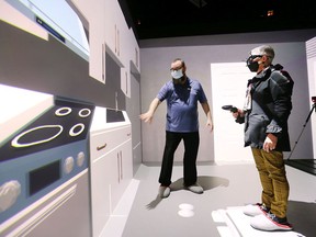 Bryan Holmes with the Invest Windsor Essex Automobility and Innovation Centre gives Leamington Mayor Hilda MacDonald a tour of the virtual reality cave on Monday, February 28, 2022.