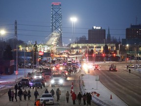 Vehicles block the route leading from the Ambassador Bridge, linking Detroit and Windsor, as truckers and their supporters continue to protest against the coronavirus disease (COVID-19) vaccine mandates, in Windsor, Ontario, Canada February 8, 2022. REUTERS/Carlos Osorio