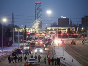 Vehicles block the route leading from the Ambassador Bridge, linking Detroit and Windsor, as truckers and their supporters continue to protest against the coronavirus disease (COVID-19) vaccine mandates, in Windsor, Ontario, Canada February 8, 2022. REUTERS/Carlos Osorio     TPX IMAGES OF THE DAY