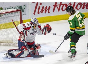 London Knights' forward Cody Morgan looks for a rebound as Windsor Spitfires' goalie Xavier Medina makes a save during a game earlier this season.
