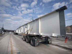 A truck carrying a steel section for the Gordie Howe International Bridge lines up to enter the Morterm Limited facility in Windsor on Tuesday, February 1, 2022.