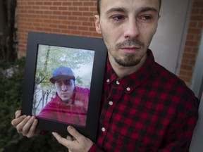 Jesse Bergeron fights back tears as he holds a photo of his late brother, Jacob Daniel Bergeron-Gervais, on Wednesday, Feb. 16, 2022. Bergeron-Gervais was found dead of an overdose in a stairwell of a residential building in the 800 block of Ouellette Avenue.