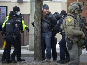 Arrests are made as police push back protesters that were congregating around Ambassador Plaza at Huron Line and Tecumseh, on Sunday, February 13, 2022.