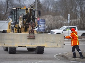 Concrete barriers are installed along Huron Church Road after police ended the Ambassador Bridge blockade, on Sunday, February 13, 2022.