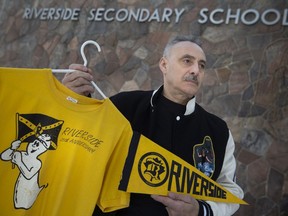 Riverside Secondary School alumnus Albert Mady shows memorabilia bearing the school's mascot Johnny Rebel. Photographed in Windsor on Feb. 1, 2022.
