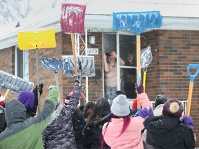 Students at Assumption College Catholic Middle School raise the shovel to grateful residents of West Windsor on February 3, 2022.