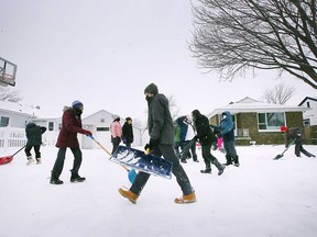 On Feb. 3, 2022, Grade 7 and 8 students from Assumption College Catholic Middle School in Windsor volunteer snow removal in the west end of the city.