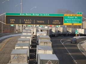 Transport trucks on the Highway 402 approach to the Blue Water Bridge are shown Tuesday morning from the Christina Street overpass.