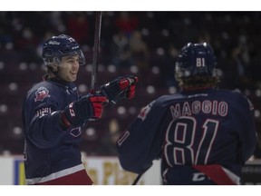 Windsor Spitfires' captain Will Cuylle and Matthew Maggio celebrate a first- period goal during Friday's game against the Flint Firebirds at the WFCU Centre.