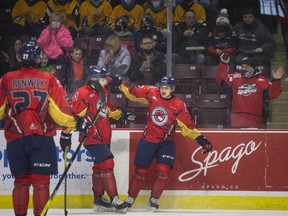 Promoted to the top line, Windsor Spitfires' rookie Ryan Abraham celebrates a first-period goal with teammates Michael Renwick and Louka Henault, during Sunday's 5-1 win over the Sarnia Sting at the WFCU Centre.