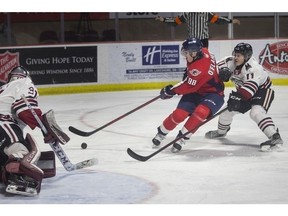 Windsor Spitfires' rookie forward Christopher O'Flaherty is unable to convert on a scoring opportunity on Guelph Storm goalie Owen Bennett while being chased by Cam Allen during Thursday's game at the WFCU Centre.