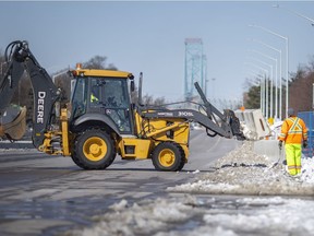 Heavy equipment removes concrete barriers on Huron Church Road at Tecumseh Road West, as east-bound and west-bound was opened up a week after police cleared the intersection of protesters, on Sunday, Feb. 20, 2022.
