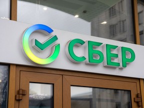 A sign above the entrance to a Sberbank of Russia PJSC bank branch in Moscow, Russia.