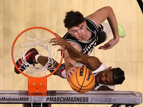 Grant Basile of the Wright State Raiders defends the shot attempt by Dalen Terry of the Arizona Wildcats during the second half in the first round game of the 2022 NCAA Men's Basketball Tournament at Viejas Arena at San Diego State University on March 18, 2022 in San Diego, California.