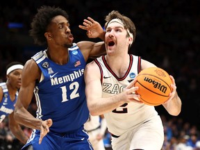 Drew Timme of the Gonzaga Bulldogs goes up for a shot in front of DeAndre Williams of the Memphis Tigers during the second half in the second round of the 2022 NCAA Men's Basketball Tournament at Moda Center on March 19, 2022 in Portland, Oregon.