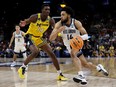 Caleb Daniels of the Villanova Wildcats drives past Moussa Diabate of the Michigan Wolverines during the second half of the NCAA Men's Basketball Tournament Sweet 16 Round at AT&T Center on March 24, 2022 in San Antonio, Texas.