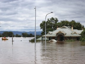 A home is seen inundated by floodwaters along the Hawkesbury River in Windsor on March 9, 2022 in Sydney.