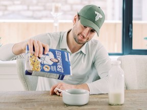 Toronto Maple Leafs forward John Tavares pouring his cereal, Recipe 91, into a bowl.