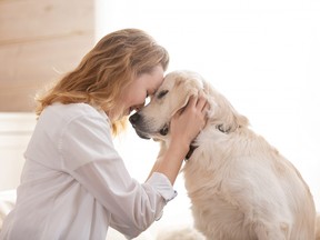 woman hugging her beloved big white dog. Animal communication concept
