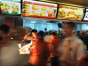 Employees serve clients in a McDonald's restaurant on Pushkin square in Moscow on February 1, 2010. ALEXANDER NEMENOV/AFP via Getty Images)