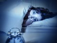 woman in bed eyes opened suffering insomnia and sleep disorder