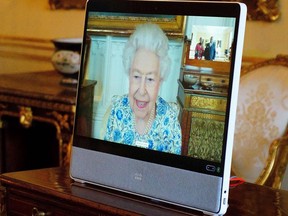 Britain's Queen Elizabeth II appears on a screen via videolink from Windsor Castle, during a virtual audience to receive the High Commissioner of Malawi, Dr. Thomas Bisika (not pictured), at Buckingham Palace in London on March 3, 2022.