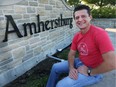 Amherstburg Mayor Aldo DiCarlo poses in front of a sign at the east entrance of town on Friday, September 22, 2017. There is controversy over the name Amherst, named after a general who supported genocide against Indigenous people.