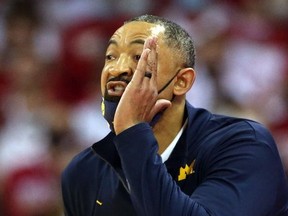 Michigan Wolverines head coach Juwan Howard  directs his team during the game with the Wisconsin Badgers at the Kohl Center.