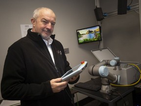 Shawn Horton, director of marketing and business development with AIS Technologies Group, is pictured inside the Demonstration Lab working with a vision based position tracking for robots, on Monday, March 21, 2022.