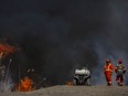 Dan Lebedyk, a biologist/ecologist at the Essex Region Conservation Authority, and Lloyd Holbrook, left, from Wildfires Specialist Inc., monitor a prescribed burn of approximately 17 hectares of Phragmites within the Callavino Wetland near the mouth of the River Canard, on Thursday, March 17, 2022.