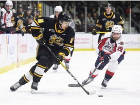 Sarnia Sting's Theo Hill (16) tries to elude Windsor Spitfires' Daniel D'Amico (29) earlier this season. The two tams are set to meet in quarter-final play on Thursday.