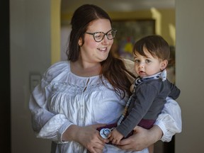 Nicole Matchett holds her 10-month-old son, Kian, at her home on Tuesday, March 29, 2022.  Matchett is pleased with the newly announced childcare announcement.