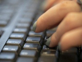 A woman types on a keyboard.