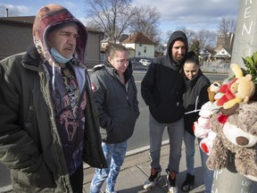 Family members of Kenny McEldowney, from left, Bryan McEldowney, brother, Alycia McEldownney, niece, David McEldowney, nephew, and Amanda McEldowney, niece, visit the location where he was struck and killed by a drunk driver while riding his bicycle, on Monday, March 28,  2022.