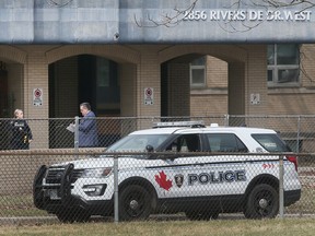 WINDSOR, ONTARIO. MARCH 30, 2022 - Windsor Police officers are shown in the 2800 block of Riverside Drive West on Wednesday, March 30, 2022 where a deceased man was found.