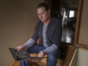Greg Marentette looks through old photos of his dog, Lemmy, that was stolen by his former dog walker three years ago, on Wednesday, March 30, 2022.