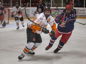 ESSEX, ONTARIO:. MARCH 13, 2022 - Essex' Conor Dembinski and Petrolia's Peyton Armitage battle for the puck in game 3 of the Junior C hockey playoffs between the Essex 73's and the Petrolia Flyers at the Essex Centre Sports Complex, on Sunday, March 13, 2022.