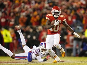 Jan 23, 2022; Kansas City, Missouri, USA; Kansas City Chiefs wide receiver Tyreek Hill (10) carries the ball past Buffalo Bills cornerback Levi Wallace (39) during the fourth quarter of the AFC Divisional playoff football game at GEHA Field at Arrowhead Stadium.