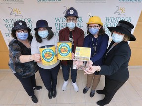 Sandra Bauer, left, Cristina Naccarato, Brandon Osbourne, Teresinha Mederios and Gisele Seguin with the Windsor Regional Hospital Foundation pose with their hats on Wednesday, March 2, 2022 for the annual Hats on for Healthcare fund-raising event.
