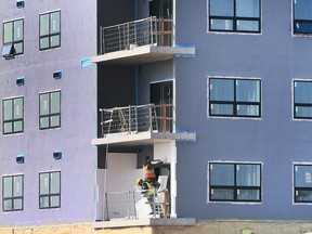 Construction workers are pictured at a condominium project on McHugh Street in Windsor Thursday, March 10, 2022.