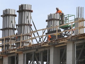Windsor regained its title in February as Canada's unemployment capital. In this March 25, 2021, file photo, construction workers are shown at the site of a multi-unit residential building project in east Windsor.